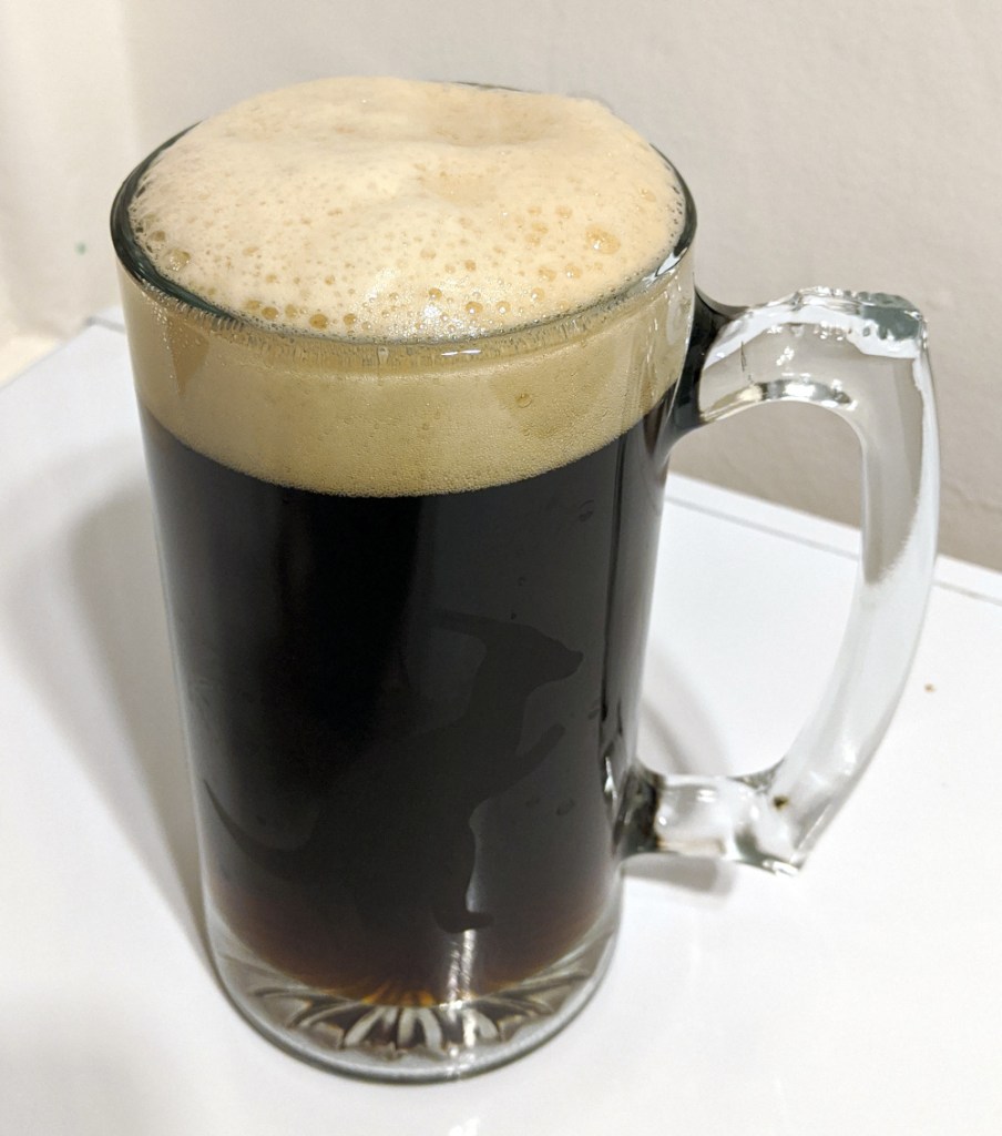 tall mug of dark lager with tan colored head